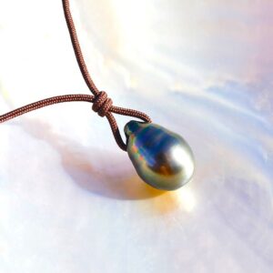 Close-up of the 12 mm drop-shaped Tahitian cultured pearl on the adjustable pendant necklace displayed on mother-of-pearl