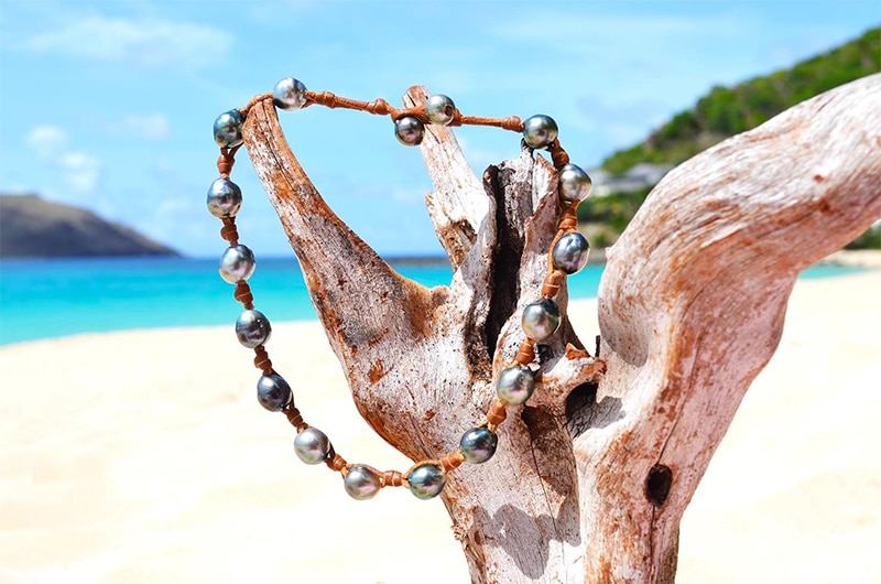 Full-length view of the convertible leather jewelry with 17 Tahitian cultured pearls hanging from driftwood
