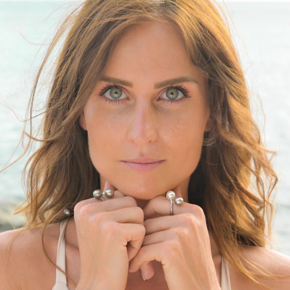 Sterling silver Toi et Moi ring with two Tahitian pearls worn on the hand near the face