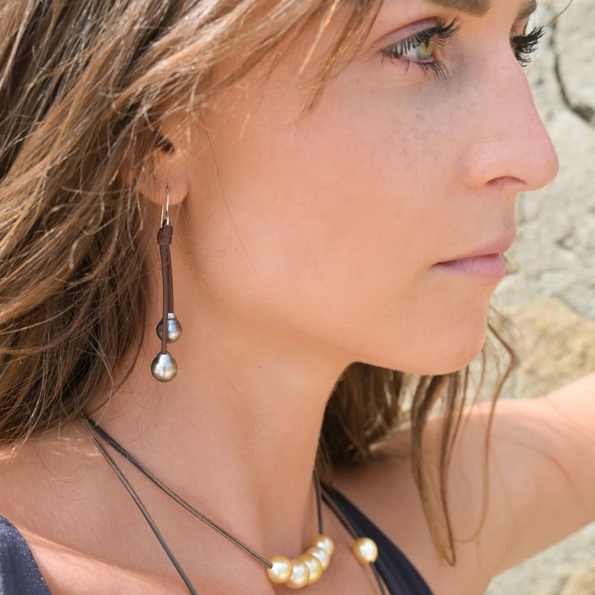Leather drop earrings with four Tahitian pearls worn in profile