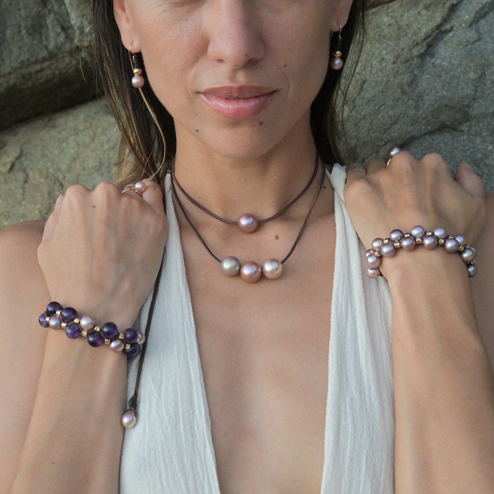Double-row bracelet with pink pearls and hammered tubes, worn in context, square view around the bracelet.
