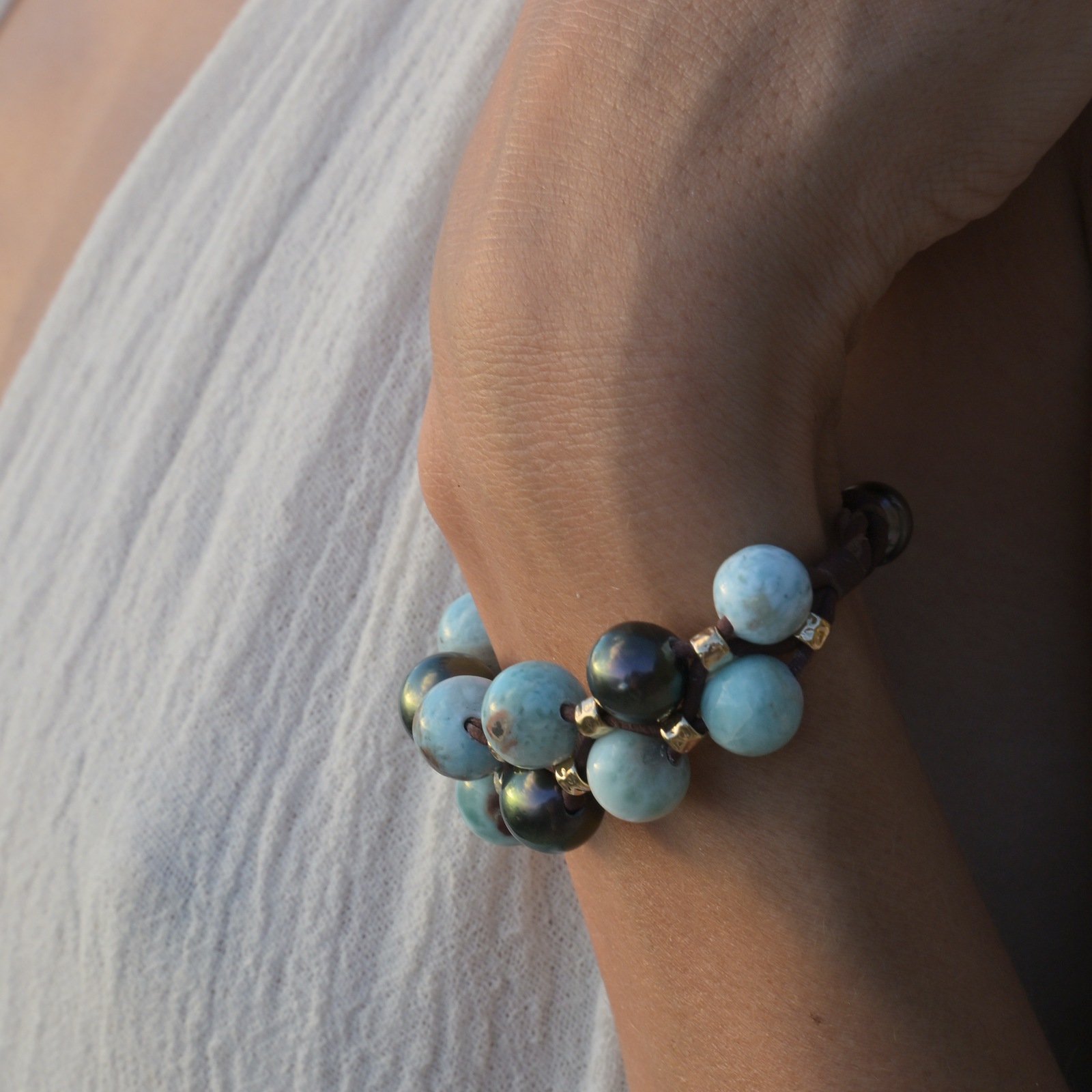 Bracelet double rang, Larimar et perles de Tahiti, au poignet.