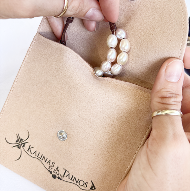 Kalinas & Tainos suede-effect pouch protecting a piece of jewelry