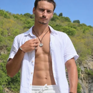 Braided Necklace with Pirate Coin worn at Shell Beach, lifestyle view with other Kalinas jewelry visible.
