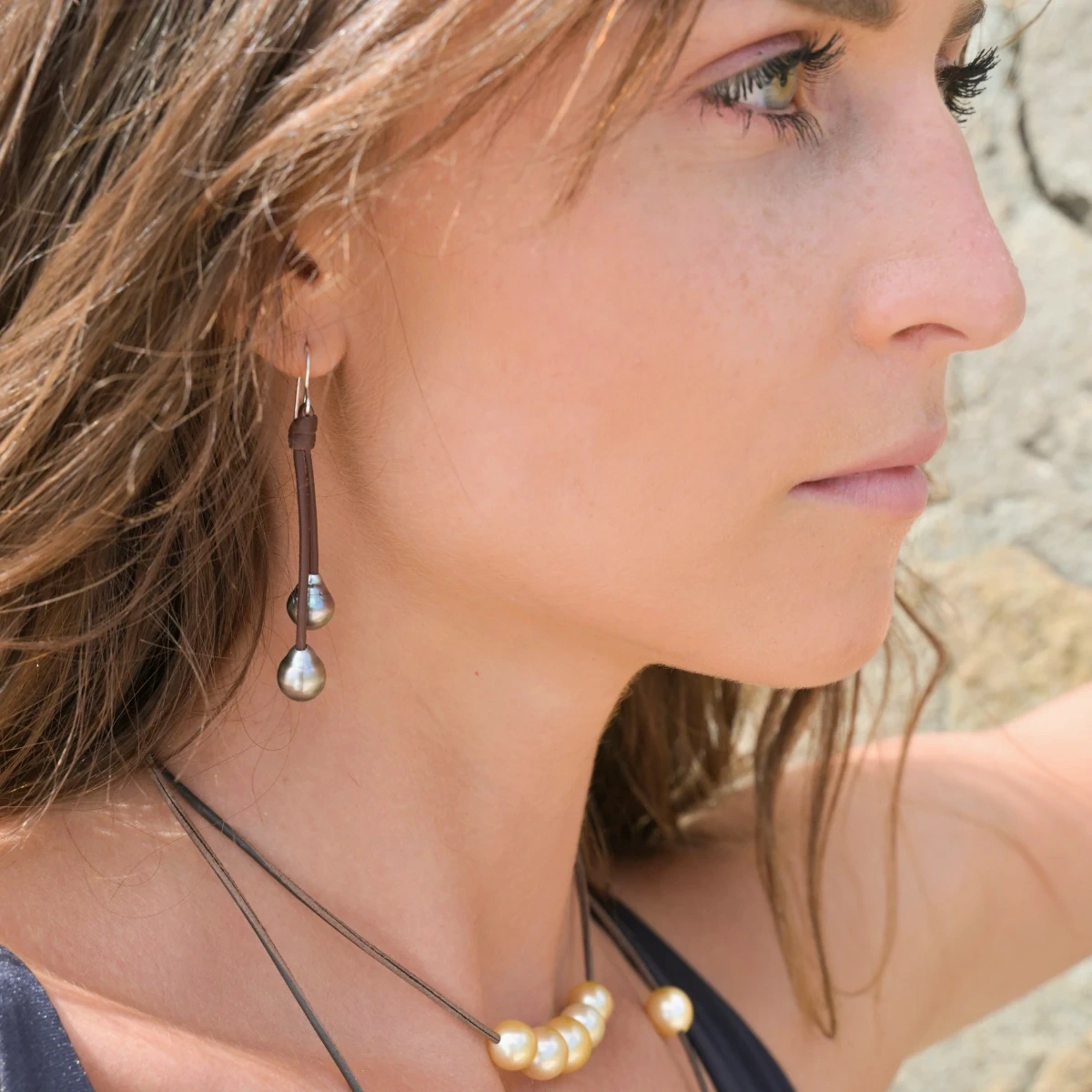Leather drop earrings with four Tahitian pearls worn in profile