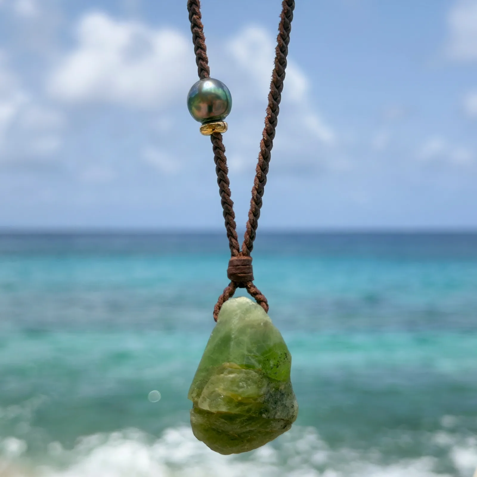 Large braided leather necklace with raw peridot.