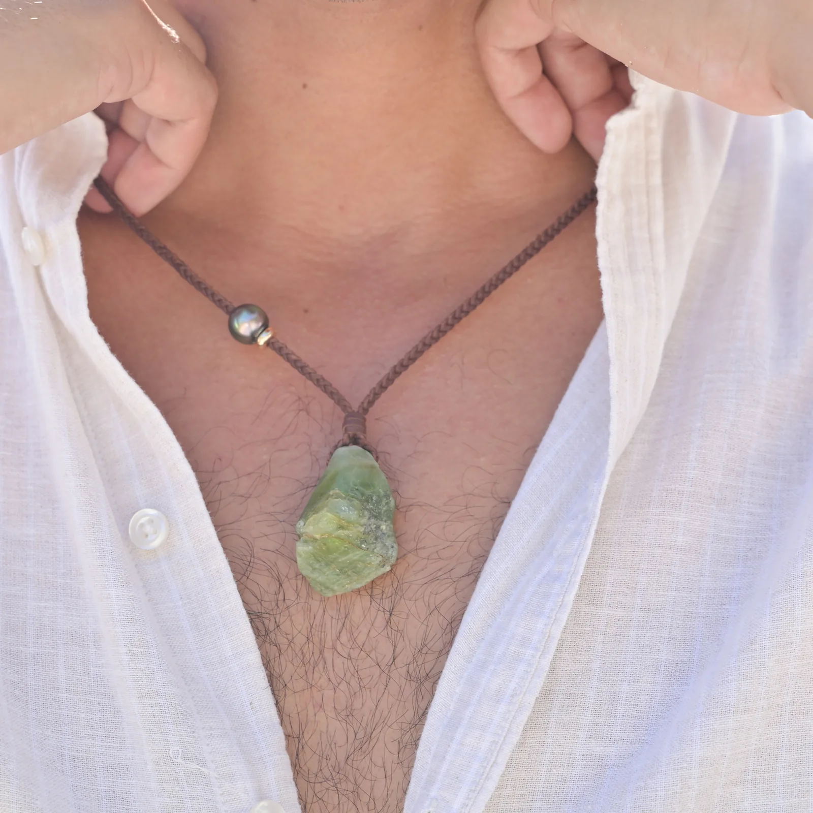 Large braided leather necklace with raw peridot, worn.