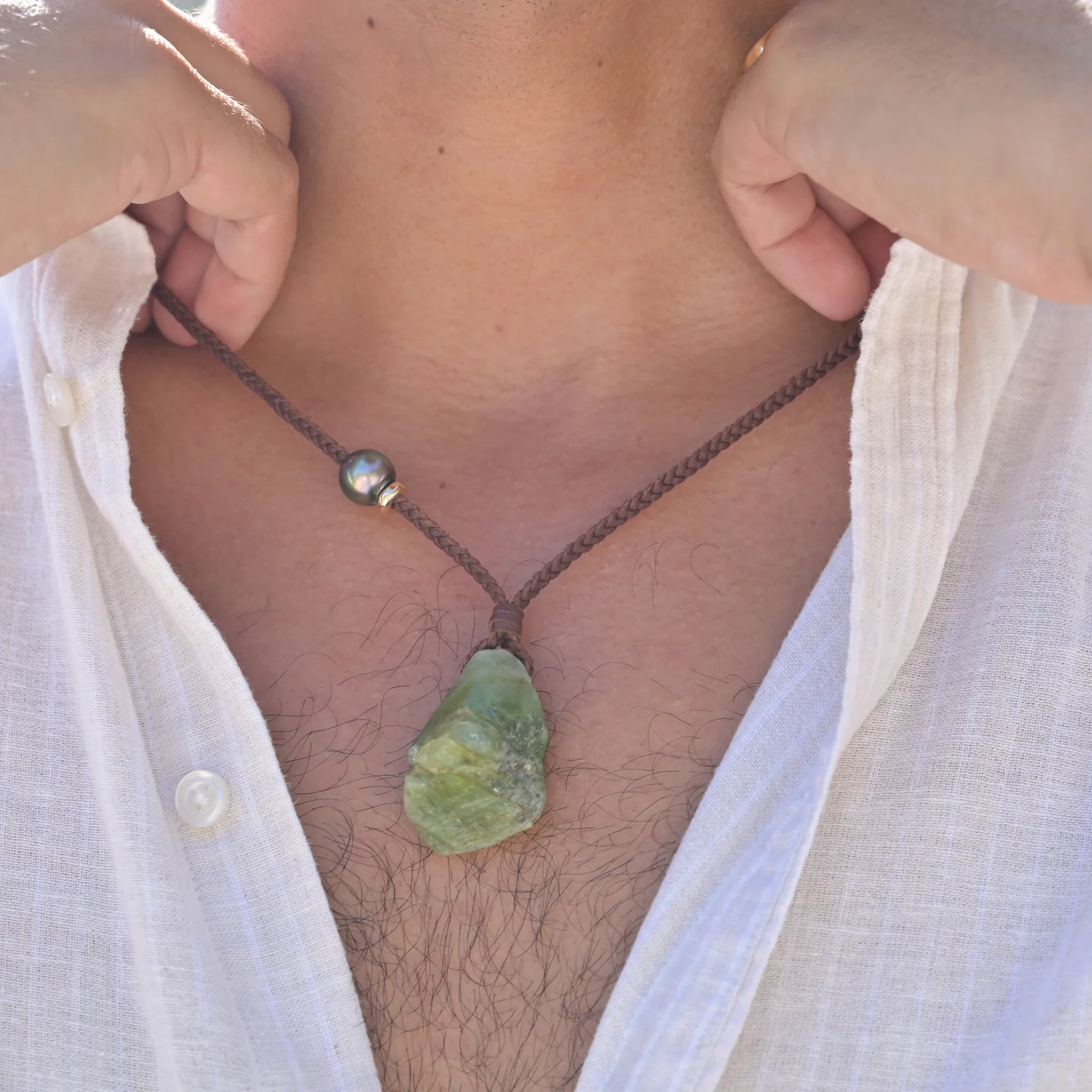 Large braided leather necklace with raw peridot, worn.
