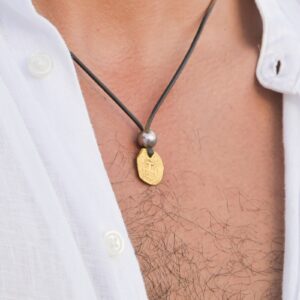 Gold Through the Centuries, an antique escudo necklace with a Tahitian pearl, close-up on the model.