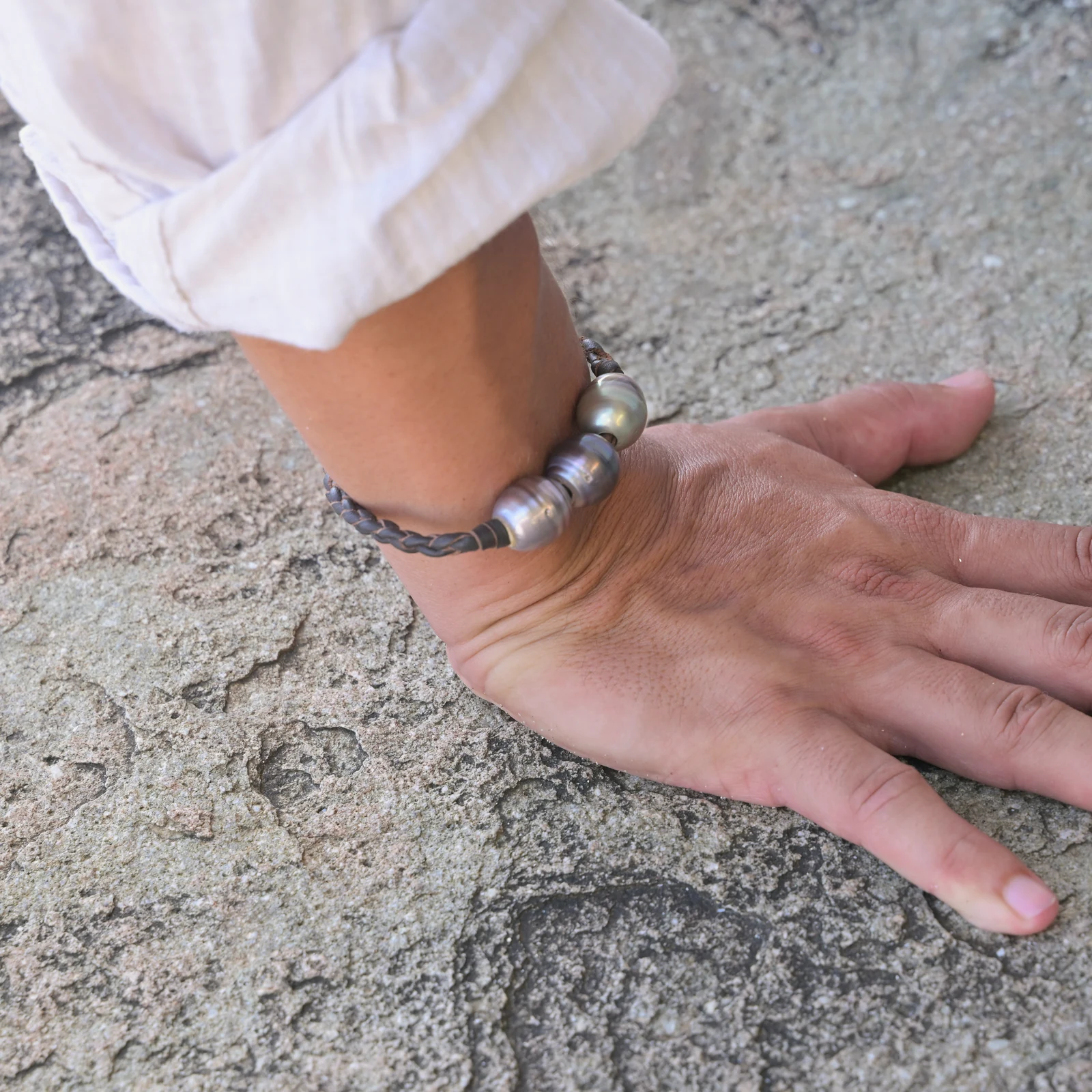 Men’s Leather Bracelet with Three Tahitian Pearls and a Choice of Construction, worn on the wrist.