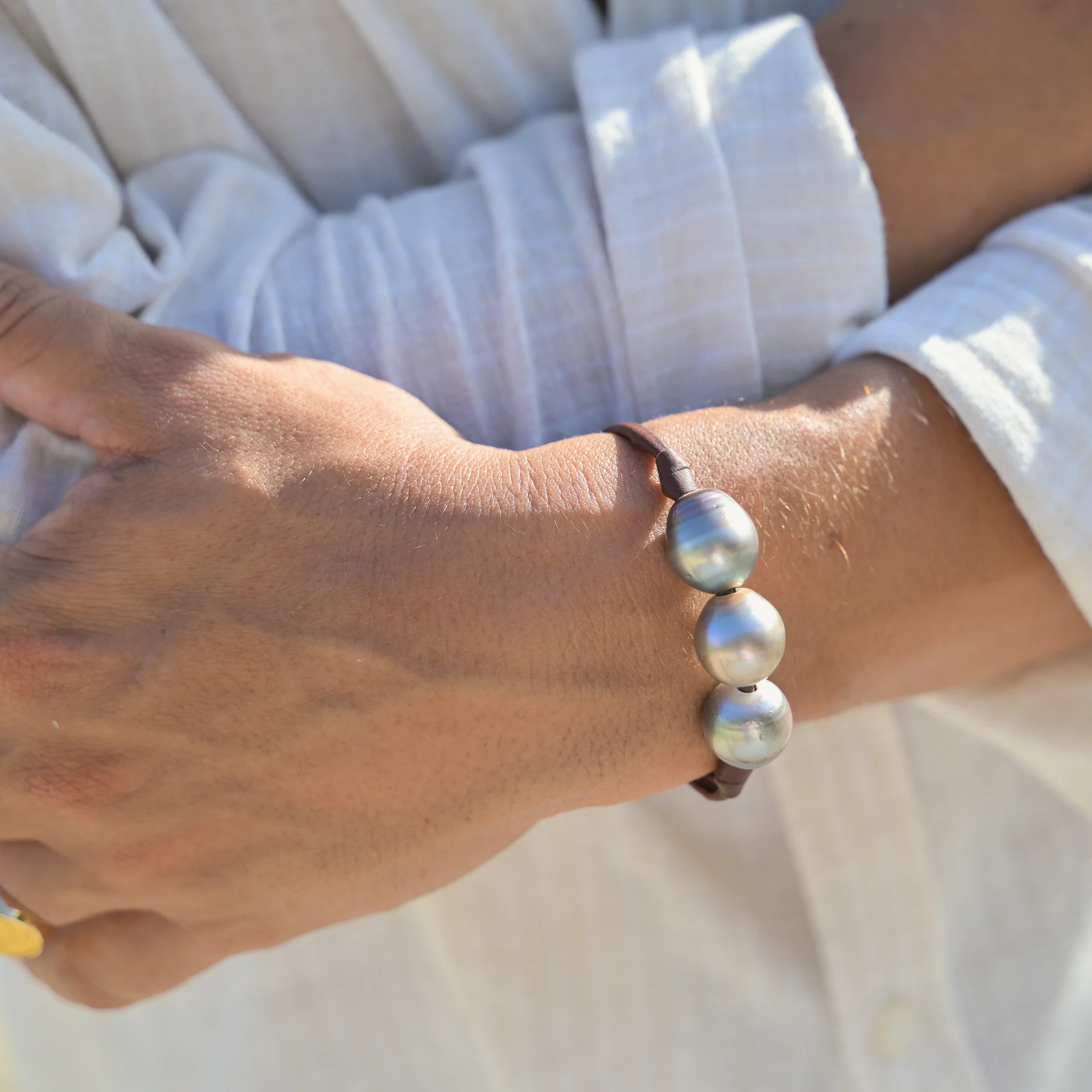 Men’s Leather Bracelet with Three Tahitian Pearls and a Choice of Construction, worn on the wrist.