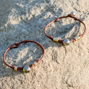 Double Leather Bracelet with a Tahitian Pearl and Gold-Plated Tubes, jewelry view.