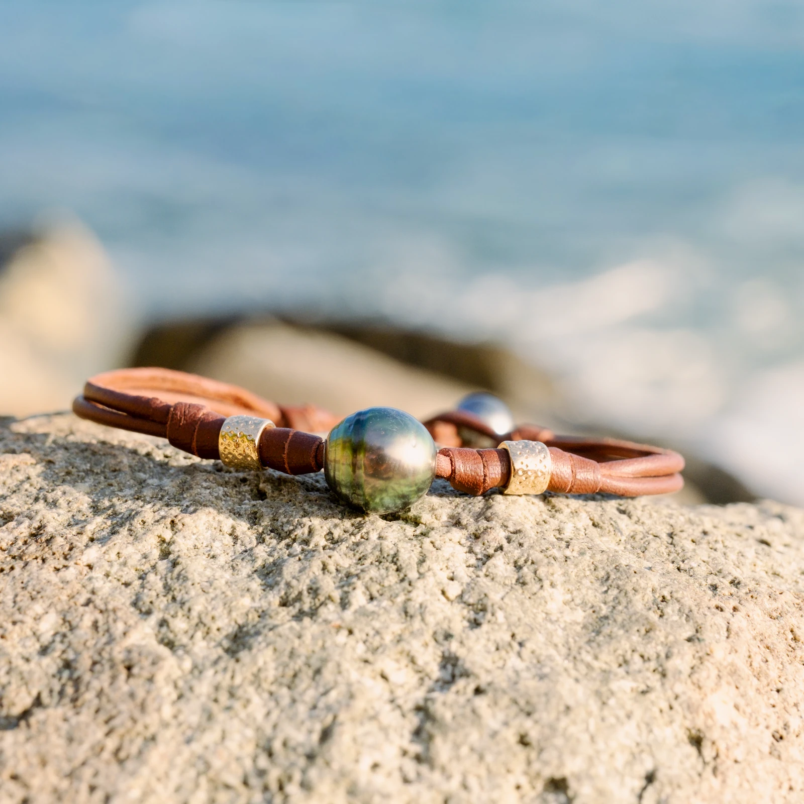 Double Leather Bracelet with a Tahitian Pearl and Gold-Plated Tubes, jewelry view.