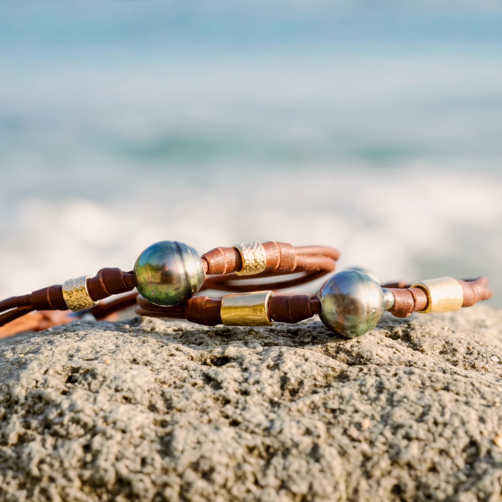 Double Leather Bracelet with a Tahitian Pearl and Gold-Plated Tubes, jewelry view.