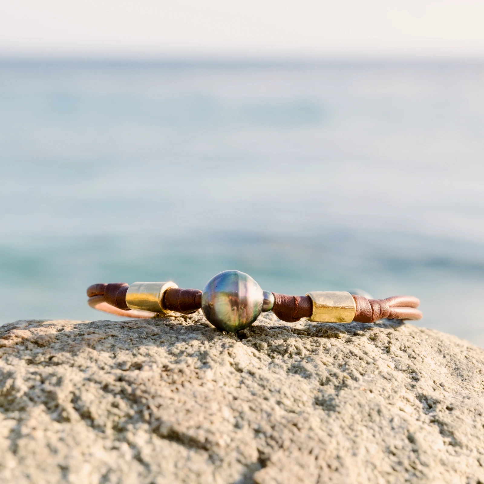 Double Leather Bracelet with a Tahitian Pearl and Gold-Plated Tubes, jewelry view.