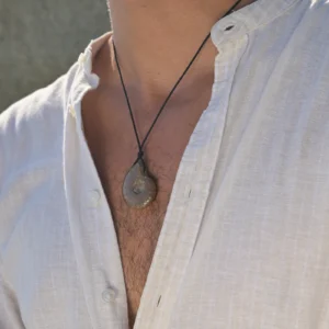 Collier ajustable avec ammonite opalisée, porté au cou.