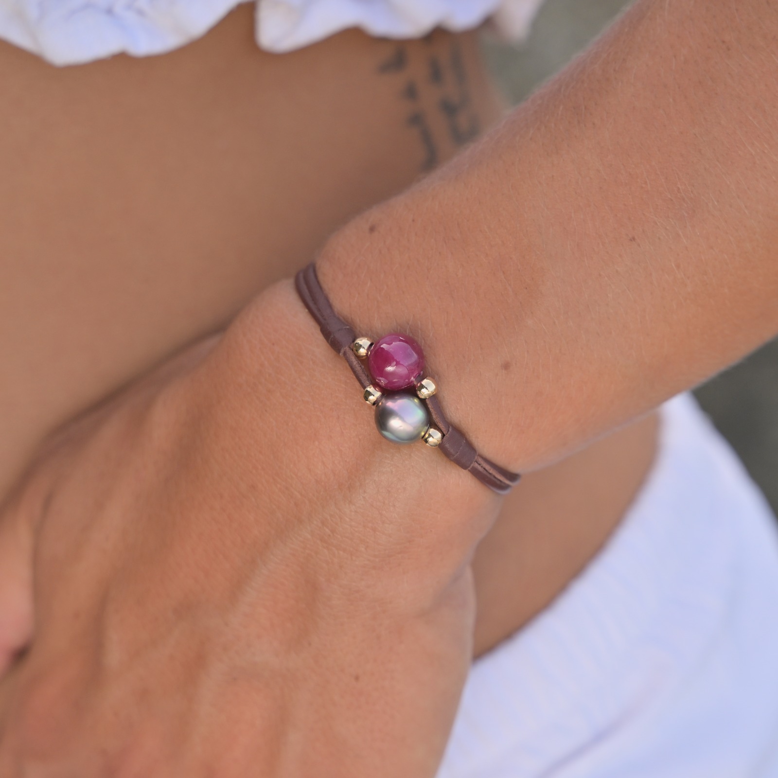 Bracelet 2 rangs en cuir, rubis et perle de Tahiti, porté au poignet