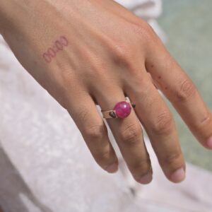 Bague en cuir et rubis, portée à la main