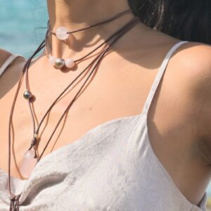 Leather choker with rose quartz, worn at the neckline