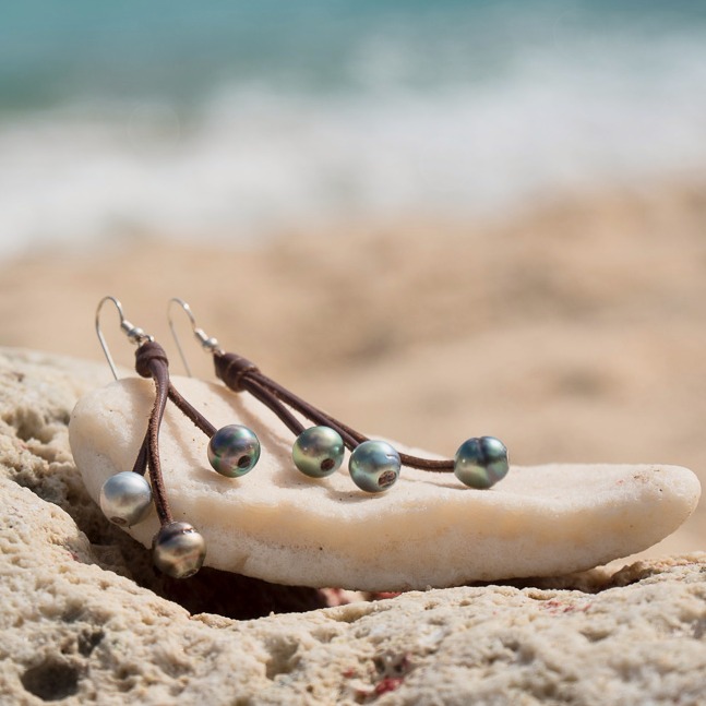 Leather earrings with six Tahitian pearls, in a natural still-life setting