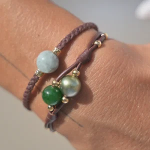 Braided leather bracelet with natural jade, worn on the wrist
