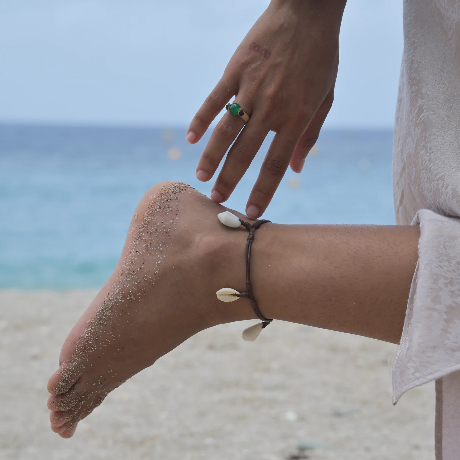 Flat leather ring with green jade, worn on the hand