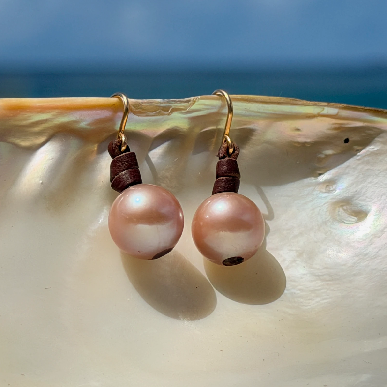 Classic leather earrings with cultured pearls, jewelry presentation