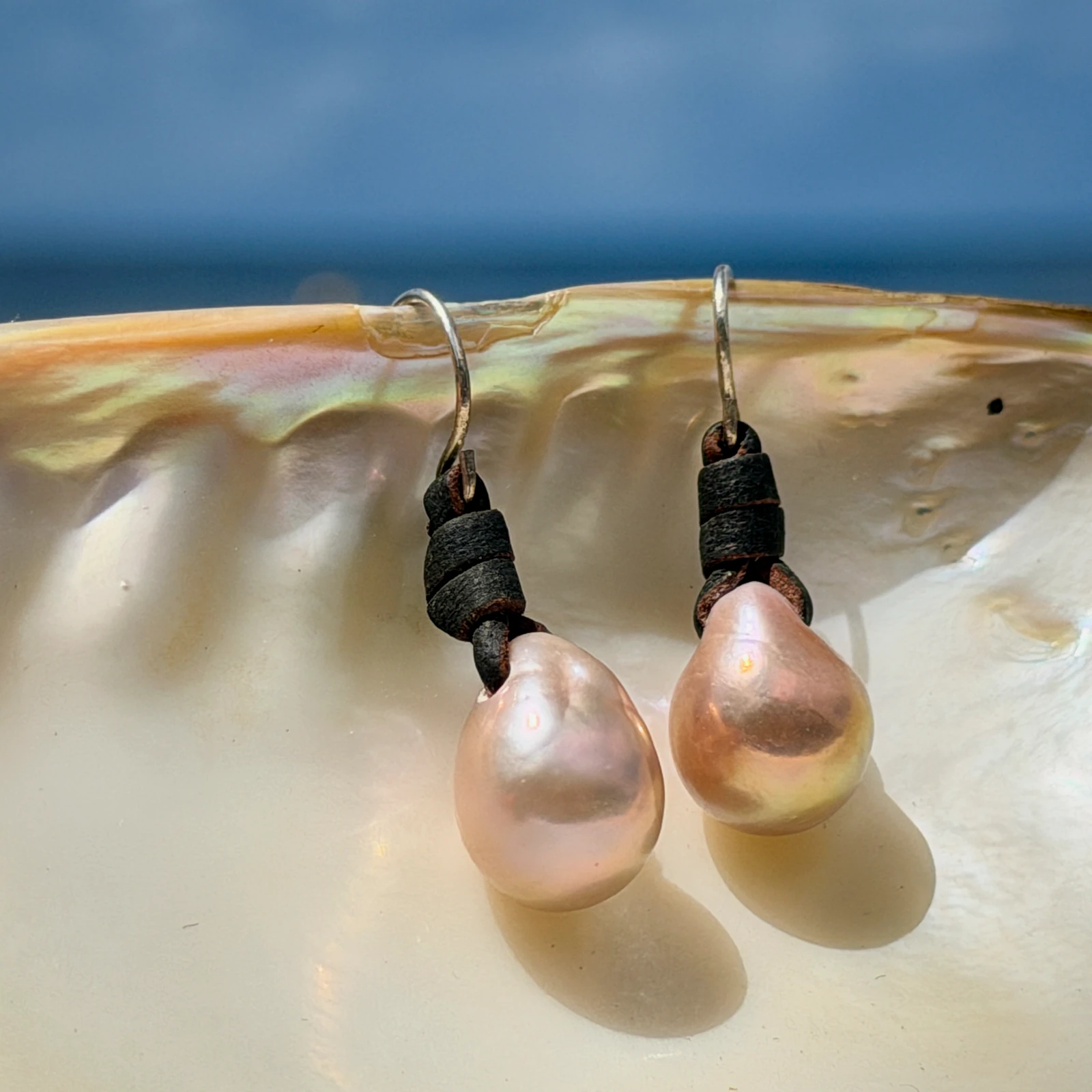 Classic leather earrings with cultured pearls, jewelry presentation