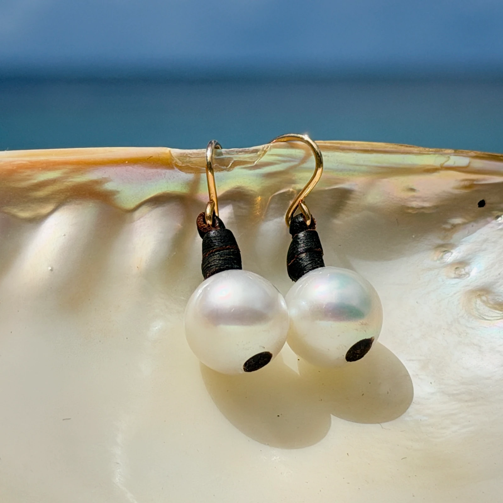 Classic leather earrings with cultured pearls, jewelry presentation