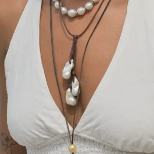 Leather necklace with a cluster of three large baroque pearls, worn
