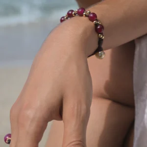 Faceted ruby bracelet with gold-plated beads and a South Sea pearl, worn
