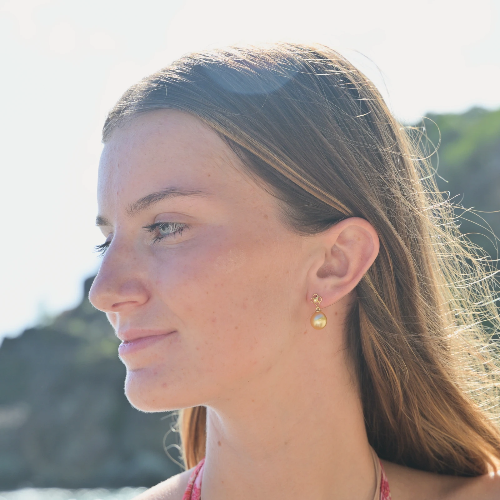 Gold Flower earrings with diamonds and a choice of pearls, worn
