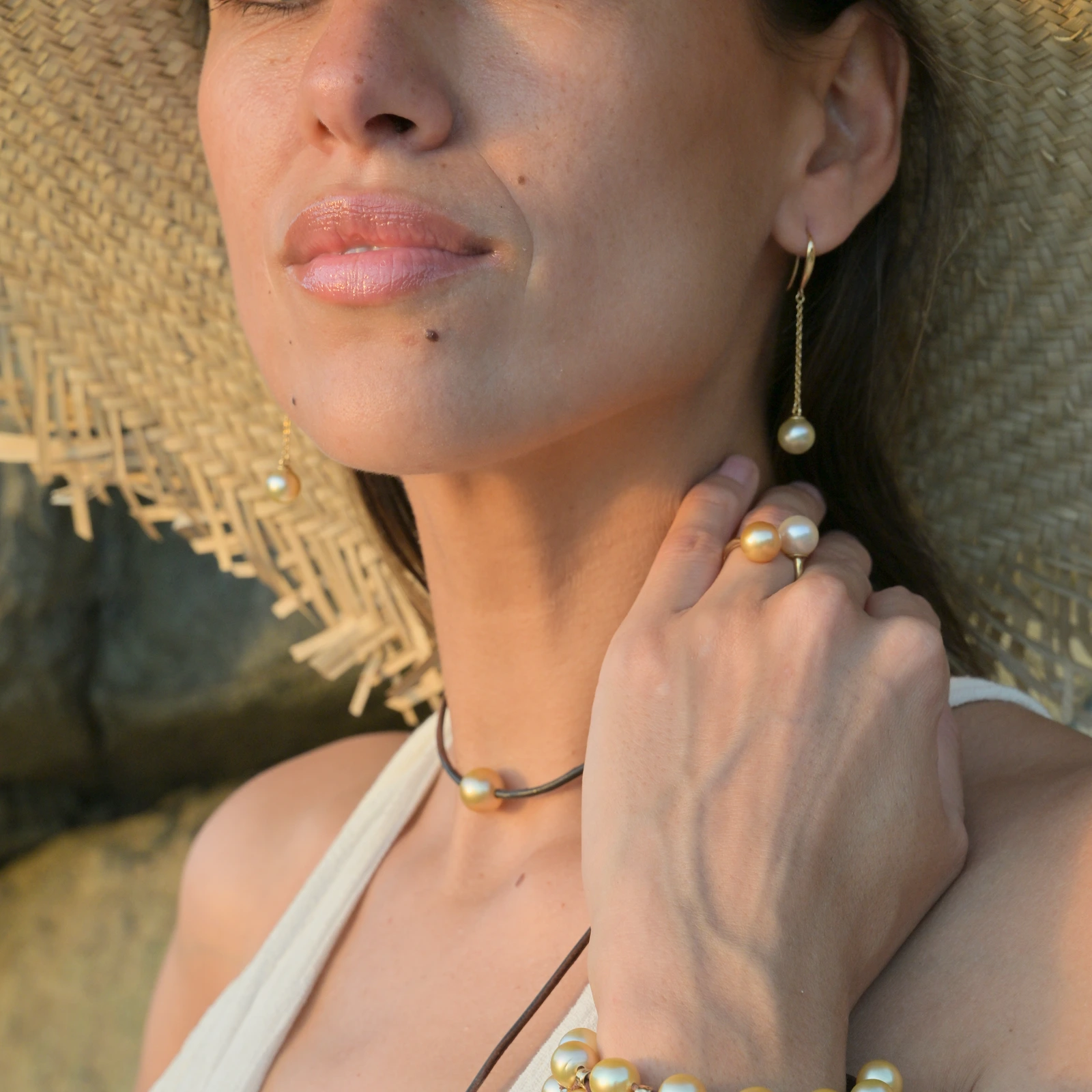 Long gold earrings with golden pearls, worn