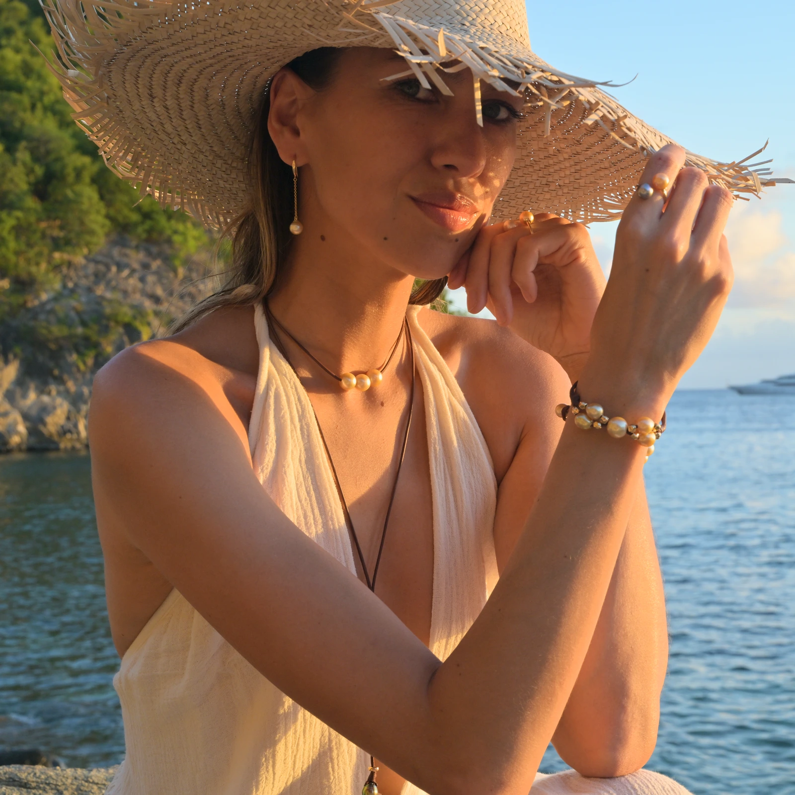 Long gold earrings with golden pearls, worn