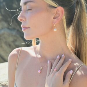 Classic gold earrings with a choice of large pearls worn on a model