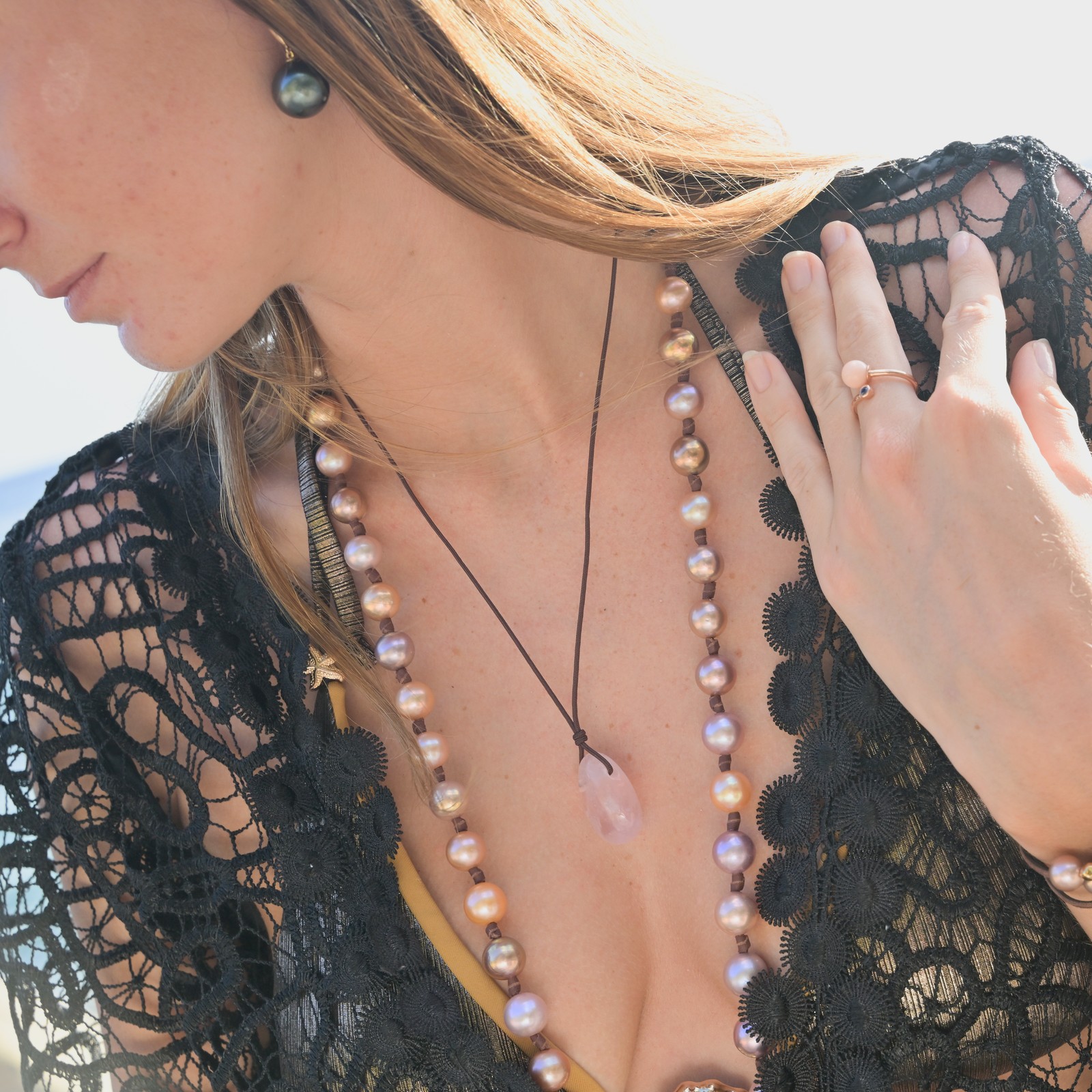 Classic gold earrings with a choice of large pearls worn on a model